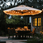 Outdoor patio illuminated with string lights and a large umbrella for evening gatherings.