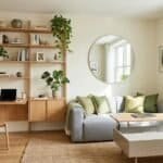 Bright and cozy small apartment living room with minimalist furniture and green plants.