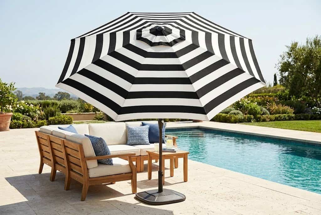 large cantilever umbrella over pool deck seating for shade and style